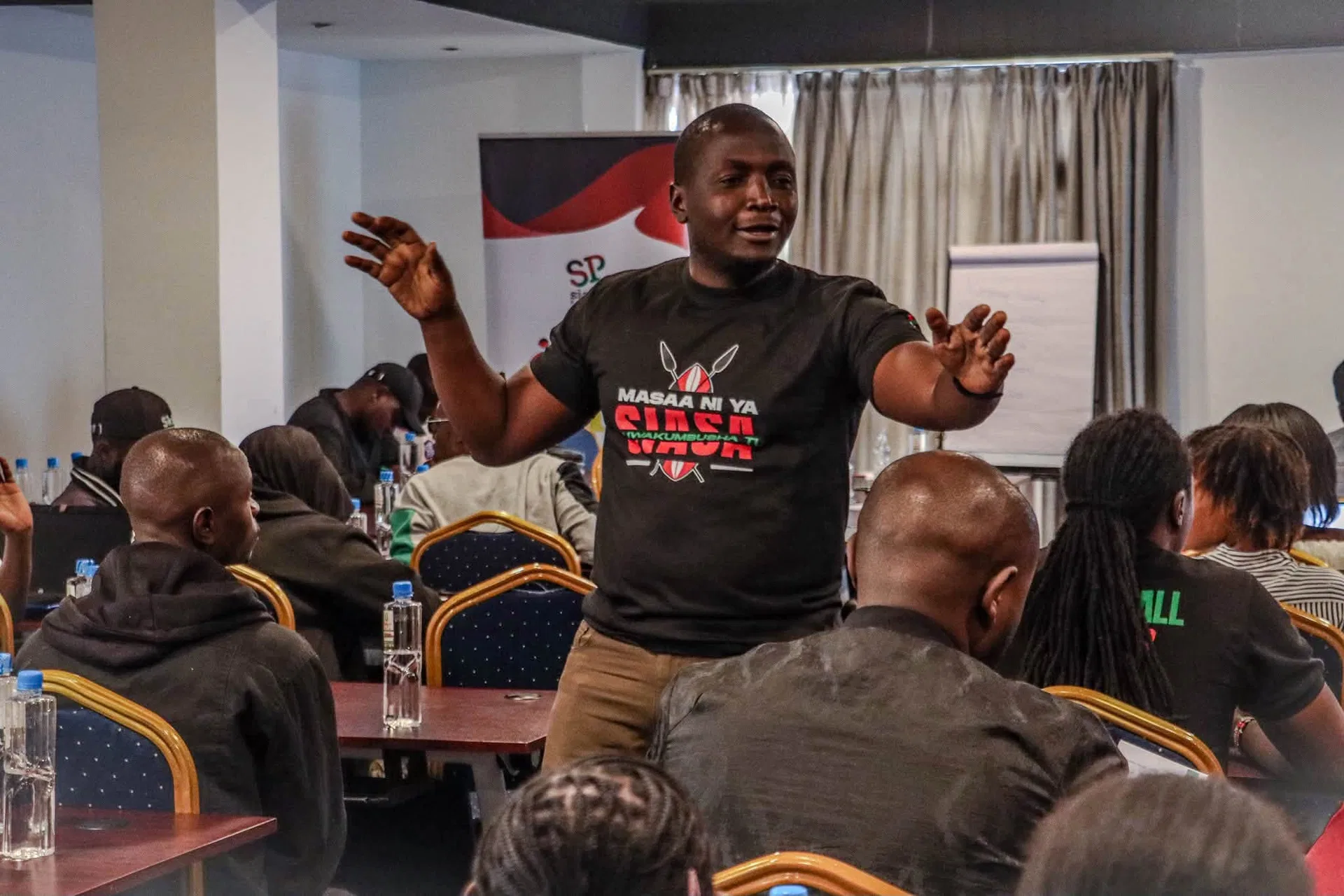 A young person shares ideas at a Siasa Place event.